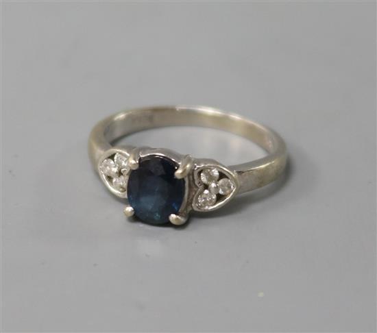 A 14ct white gold, sapphire and diamond ring, size H.